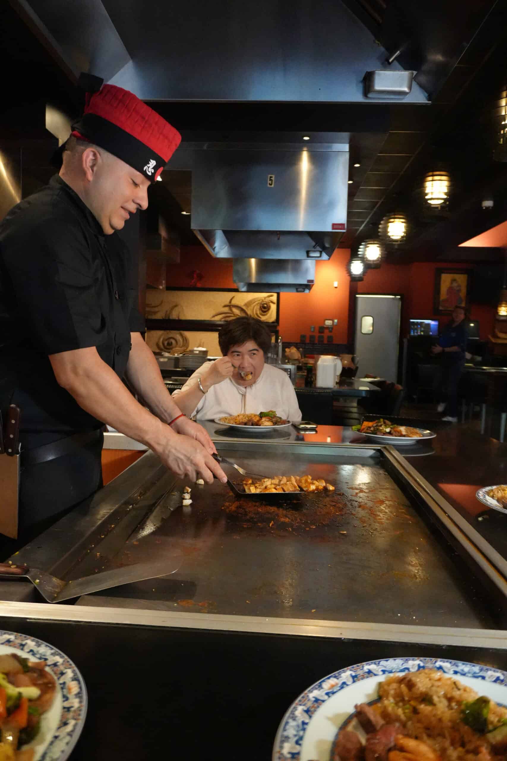 Chef preparing teppanyaki at Osaka Japanese Cuisine restaurant.